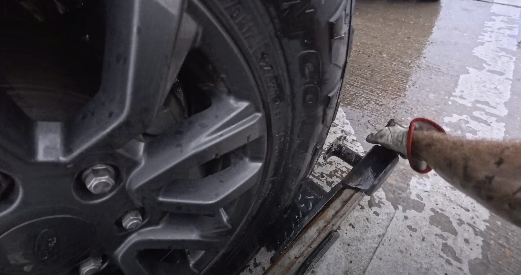 Professional winching equipment securing vehicle wheel for recovery